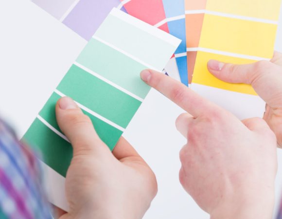 People choosing and comparing paint color samples for renovation